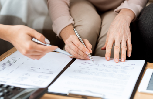 hands mature client real estate agent with pens pointing contract before signing it 1