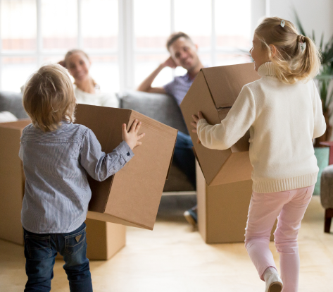 rear view kids playing with boxes moving day 1